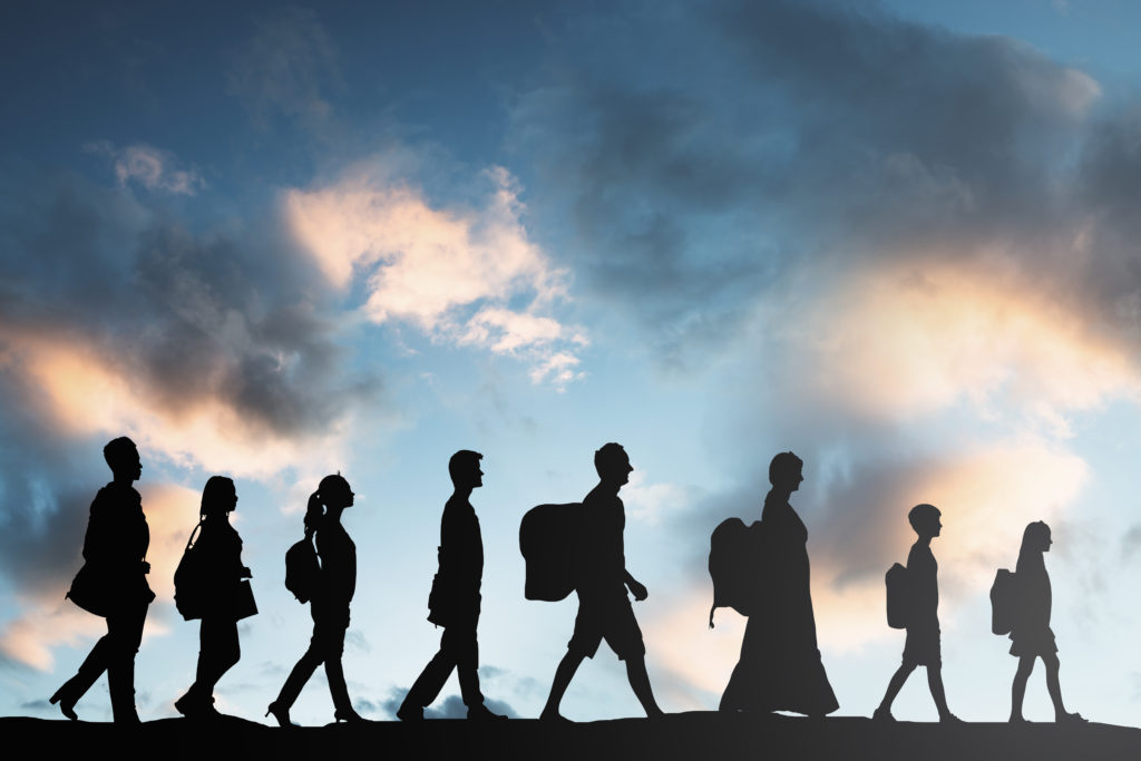 Refugees  With Luggage Walking In A Row 